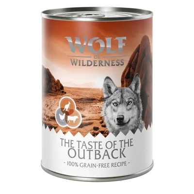 Lata de comida para perros Wolf of Wilderness, The Taste of the Outback, 100% grain-free recipe. Fondo con paisaje desértico y siluetas de animales en el envase.