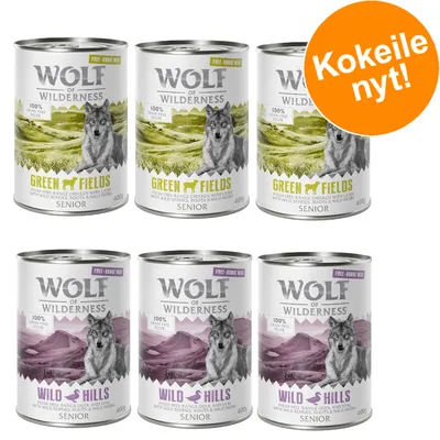 Wolf of Wilderness Senior -koiran märkäruokaa: Green Fields ja Wild Hills, 400 g purkit. Oranssi ympyrä tekstillä 'Kokeile nyt!'.