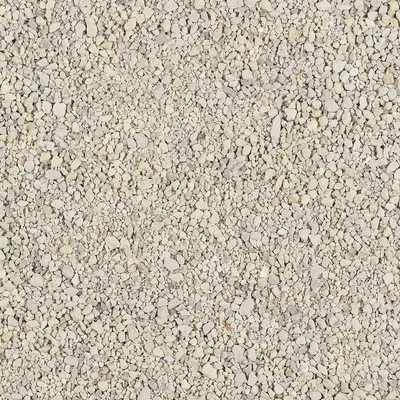 Zbliżenie na jasnoszary żwirek o drobnej, nieregularnej granulacji. Widoczne różne rozmiary i kształty ziaren.