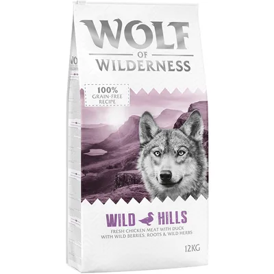 Sac de croquettes Wolf of Wilderness Wild Hills, 12 kg, recette sans céréales, poulet frais et canard, baies sauvages, racines et herbes. Texte en anglais sur l'emballage.