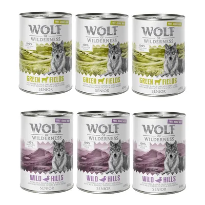 6 conserve Wolf of Wilderness Senior, 3 Green Fields cu pui și miel, 3 Wild Hills cu rață și vițel, fiecare 400g. Text vizibil: 100% grain-free recipe, free-range meat.