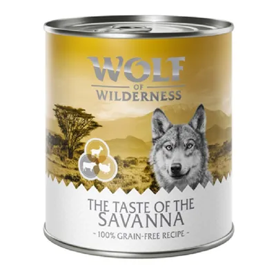 Conservă Wolf of Wilderness The Taste of the Savanna, 100% grain-free recipe, imagine cu animale și peisaj de savană pe ambalaj. Text în limba engleză.