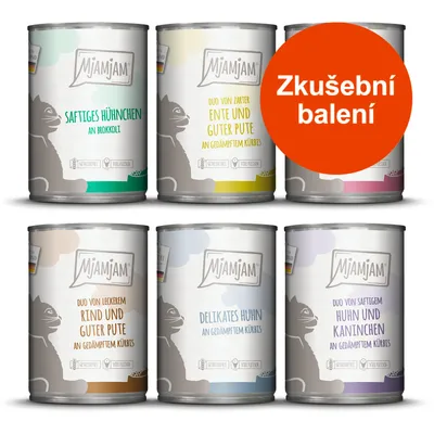 Sada šesti konzerv MjAMjAM s různými příchutěmi, nápis Zkušební balení na oranžovém kruhu. Viditelné texty v němčině: SAFTIGES HÜHNCHEN, RIND UND GUTER PUTE, DELIKATES HUHN aj.