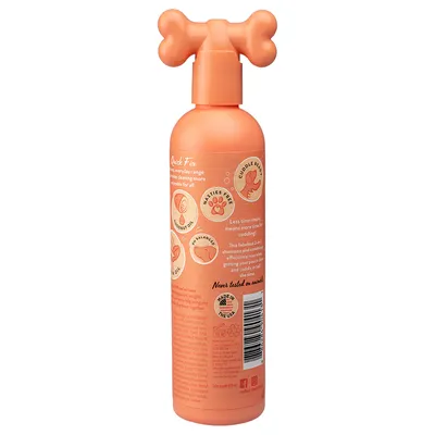 Orange flaske med knogleformet pumpe. Synlig tekst: Quick Fix, CUDDLE READY, NASTIES FREE, COCONUT OIL, pH BALANCED, Never tested on animals, MADE IN THE USA. Stregkode synlig.