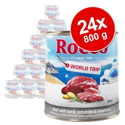 Lot de 24 boîtes Rocco World Trip 800 g, étiquette visible : Beef with lamb, potatoes & rosemary. Illustration de viande, pommes de terre et paysage méditerranéen sur l’emballage.