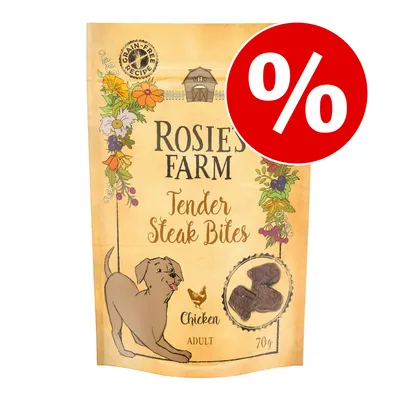 Pachet Rosie's Farm Tender Steak Bites Chicken Adult 70g, rețetă fără cereale, imagine cu bucăți de snack și simbol promoțional procentual roșu în colțul dreapta sus.
