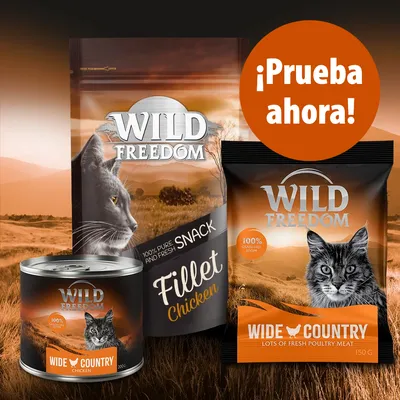 Tres productos Wild Freedom para gatos: lata y bolsas con texto visible 'Wide Country Chicken', 'Fillet Chicken', '100% grain free recipe'. Círculo naranja: '¡Prueba ahora!'.