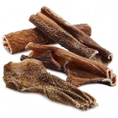 Dried beef tripe pieces, brown and textured surface, suitable as a natural chew snack. Dried beef tripe pieces, brown and textured surface, suitable as a natural chew snack.