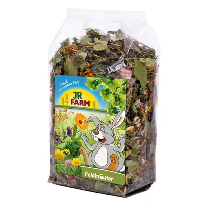 JR Farm peltoyrtit, tuoreena tilalta. Pakkaus kuivatuilla yrteillä ja kuvitus onnellisesta kanista kukkaniityllä.