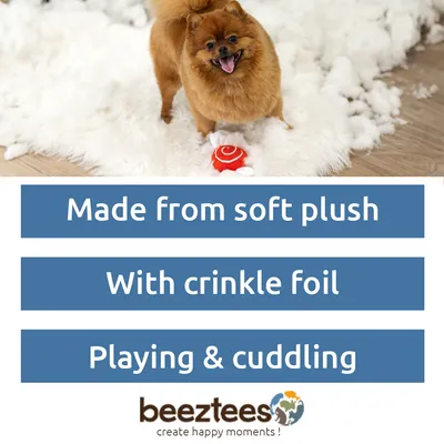 Dog with toy on carpet. Text: Made from soft plush, With crinkle foil, Playing & cuddling. beeztees create happy moments!