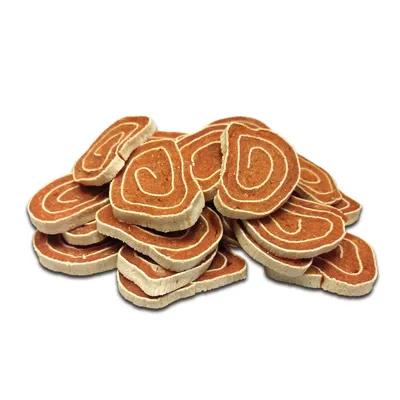 Several red and white, spiral-shaped dog snacks in disc form, visibly stacked.