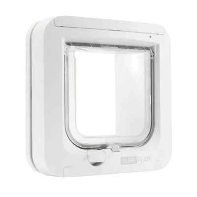 White microchip pet door with clear flap and manual lock, shown from the front at an angle. Brand name 'SureFlap' visible on lower right. White microchip pet door with clear flap and manual lock, shown from the front at an angle. Brand name 'SureFlap' visible on lower right.