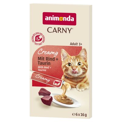 Animonda Carny Creamy mit Lachs und Taurin, 6 x 15g. Abgebildet: Katze neben cremiger Paste auf Teller.