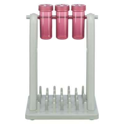 Jeu d’intelligence pour animaux avec trois tubes en plastique rose suspendus sur un support gris, base à picots. Aucun texte visible.