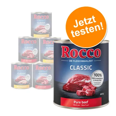 Rocco Classic Pure beef, boîte 800 g. Texte visible : 100 % fresh ingredients & grain-free. Pastille orange avec texte allemand : Jetzt testen! Autres variantes visibles en arrière-plan. Rocco Classic Pure beef, boîte 800 g. Texte visible : 100 % fresh ingredients & grain-free. Pastille orange avec texte allemand : Jetzt testen! Autres variantes visibles en arrière-plan.