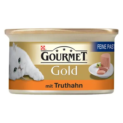 Blik Gourmet Gold kattenvoer, tekst: 'FEINE PASTETE', 'GOURMET Gold mit Truthahn', afbeelding van witte kat en kalkoenpaté op een bord.