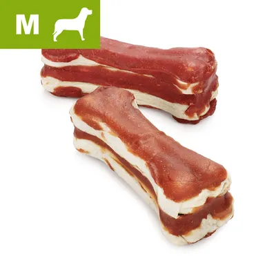 To hundesnacks i form af ben med rød og hvid overflade. Grøn markering med bogstavet M og ikon af mellemstor hund øverst til venstre. To hundesnacks i form af ben med rød og hvid overflade. Grøn markering med bogstavet M og ikon af mellemstor hund øverst til venstre.
