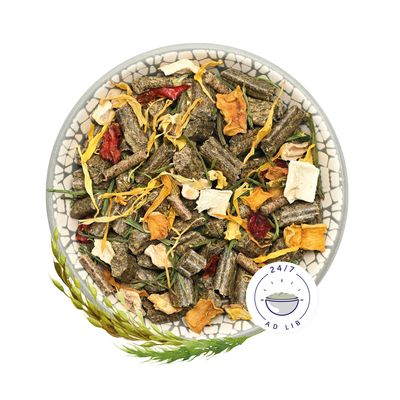 Miska se sušenými bylinkami, zeleninou a peletami. Symbol „24/7 Ad Lib“ vpravo dole.