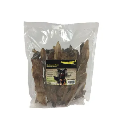 Confezione trasparente di Caniland Kaninchenohren, orecchie di coniglio essiccate per cani, etichetta nera e gialla con immagine di cane e testo in tedesco, peso netto 200 g visibile.