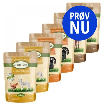 Flere poser Lukullus hundefoder, synlige varianter: Geflügel & Lamm. Blå cirkel med teksten 'PRØV NU' dækker delvist nogle poser. 300 g står på hver pose.