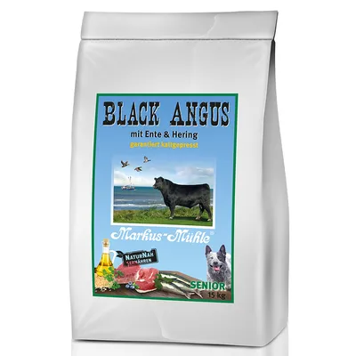 Saco de 15 kg de ração Markus-Mühle Black Angus mit Ente & Hering, texto em alemão, imagem de vaca, peixe, carne, óleo e cão, indicação SENIOR visível na embalagem.