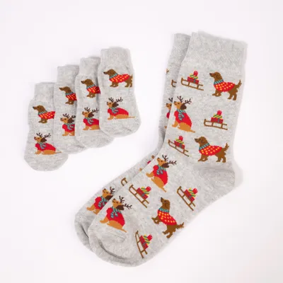 Set aus grauen Socken und vier kleinen Söckchen mit Motiv von Hund im roten Pullover, Rentier und Schlitten mit Geschenken. Set aus grauen Socken und vier kleinen Söckchen mit Motiv von Hund im roten Pullover, Rentier und Schlitten mit Geschenken.