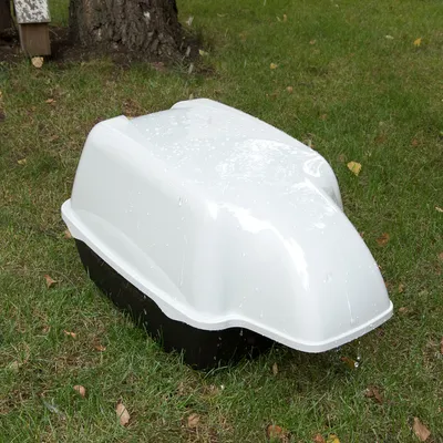 White and black plastic cover on grass, suitable as protection against rain or moisture. White and black plastic cover on grass, suitable as protection against rain or moisture.