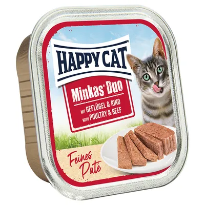 Happy Cat Minkas Duo Paté fine con pollame e manzo. Raffigurato: cibo per gatti a forma di paté su piatto bianco, gatto sullo sfondo.