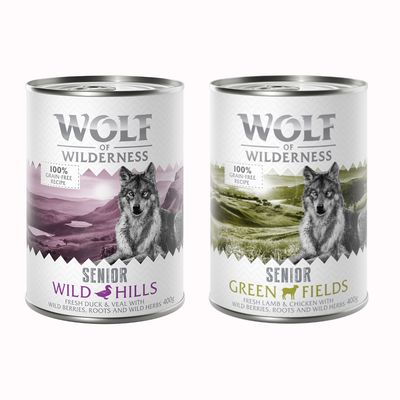 Konzerva Wolf of Wilderness Senior Wild Hills, 100% grain-free, 400 g. ENTE & KALB MIT WALDBEEREN, WURZELN UND WILDKRÄUTERN. Obraz vlka na horském pozadí.