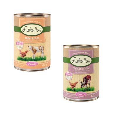 Lukullus Huhn & Kalb Junior, 24 x 400 g dåser. Tekst: Extra calcium & phosphorus, mit Haferflocken, Möhre und Leinöl. Billede af kylling og kalv på etiketten.