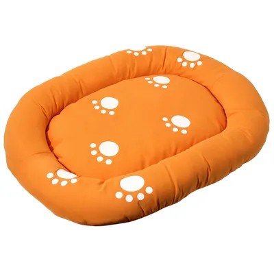Orangefarbenes ovales Haustierbett mit weissen Pfotenabdrücken auf der Oberfläche.
