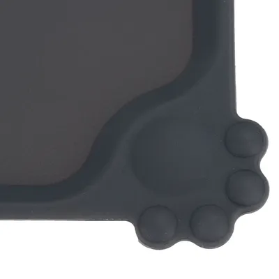 Close-up of a black mat with a paw shape in the corner, suitable as a base for food bowls or water dishes.