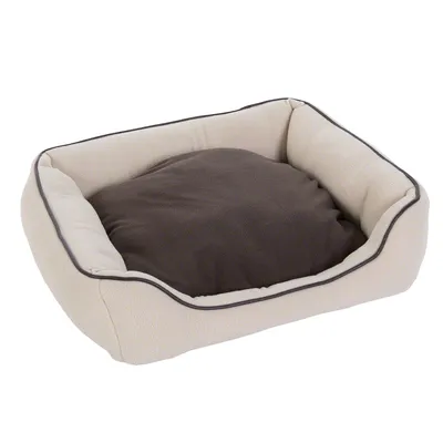 Panier pour animal rectangulaire, rebords hauts en tissu beige et coussin central amovible marron. Aucun logo ou texte visible.