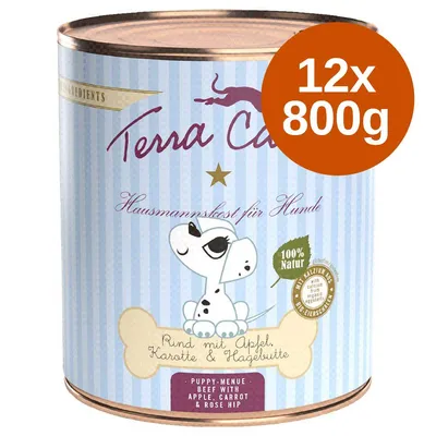 Terra Canis kutyakonzerv, 12×800g. Rind mit Apfel, Karotte & Hagebutte. Puppy-Menue: beef with apple, carrot & rose hip. 100% Natur felirat látható a dobozon.