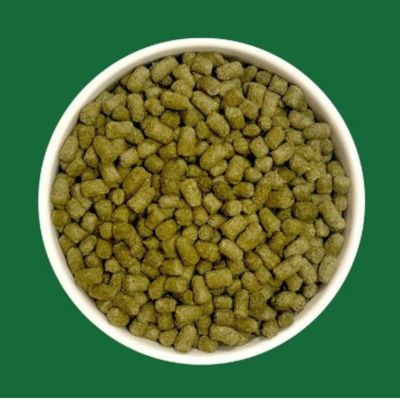 Bowl with green pellets, close-up of the food to show the shape and colour.