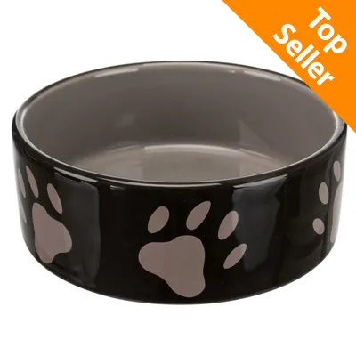 Ciotola in ceramica nera con impronte di zampa beige, bordo interno grigio. Etichetta arancione in alto a destra con testo: Top Seller.
