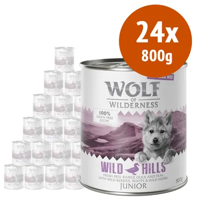 Wolf of Wilderness Wild Hills Junior, confezione 24x800g. Testo visibile: 100% grain-free recipe, fresh free-range duck and veal with wild berries, roots & wild herbs.