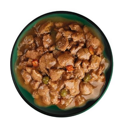 Chunks of meat in gravy with visible peas and carrot pieces served in a bowl, showing the texture and ingredients of the wet pet food.