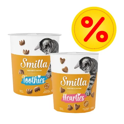 Lot de 2 boîtes Smilla pour chat : Tooshies 125 g et Hearties 125 g, avec symbole de réduction en haut à droite. Textes visibles : 'Food for a lifetime', 'Supports dental care', 'With animal protein'.