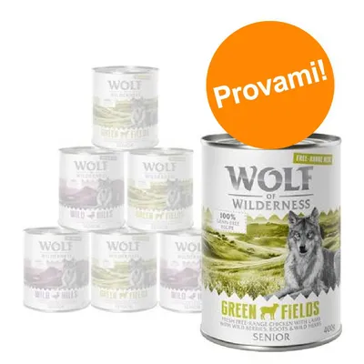 Lattina Wolf of Wilderness Green Fields Senior 400g, visibile scritta 'Provami!' su bollino arancione. Altre lattine della stessa marca sullo sfondo.