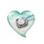 Metal scoop with blue handle, filled with white cat litter granules in a heart-shaped container.