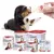 Puppy being bottle-fed with Beaphar Lactol milk replacer, surrounded by various Lactol puppy and kitten milk products and feeding accessories.