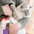 Person holding a cat next to Beaphar CatComfort Calming Spray packaging, highlighting pocket sized spray for travel and vet visits, pheromones, and reduced problem behaviours.