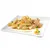 Chunks of meat with green peas and orange carrot pieces in gravy on a white square plate, garnished with a small herb and orange peel. No visible brand or text.