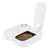 White automatic feeder with open compartment filled with dry food. Timer adjustment dial visible.
