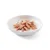 Morceaux de viande rose et beige dans une sauce claire, présentés dans une assiette blanche sur fond uni. Aucun emballage ni marque visible.