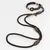 Black dog lead with brown leather details and metal fastenings, including collar with coloured accents.