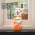 Dreamies Meaty Sticks with chicken, 90% meat. Text in image: Irresistible to cats. Cat shown behind window looking at the product.