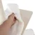 Hand showing removable white plush cushion with Velcro fastener on a wooden platform next to a sisal scratching post.