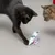 Two cats playing with a tropical print fabric toy with colourful ribbons.